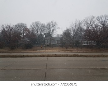road with house, trees, and snow flurries - Shutterstock ID 772356871