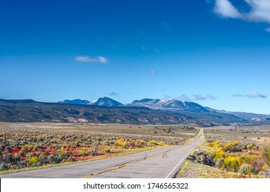 The road intersects the plain and rests against the mountains.