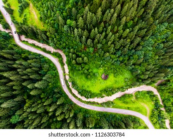 The road intersects with the river in the forest mountain - Shutterstock ID 1126303784