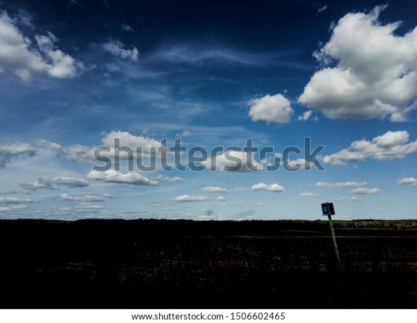 Road into the distance and a blue sky with clouds.
Over your head.