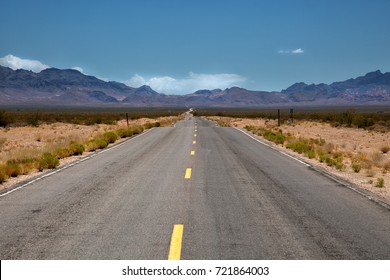Road into Valley of fire in Nevada with mountains in background