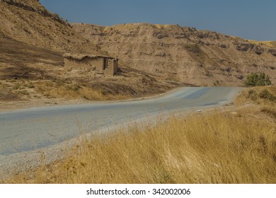 Road In Iraqi Desert With A House On The Side Of The Road Used As A Shelter For Shepherds And Farmers 