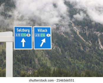 Road junction in the border between Austria and Italy with signs for the cities of Salzburg and Villach and name of the motorways