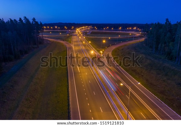 Road junction. Road junction far from the city.\
Night highway. The concept is transport infrastructure. Road\
junction in the country. Lights on the night driveway. Expressway\
in the country.