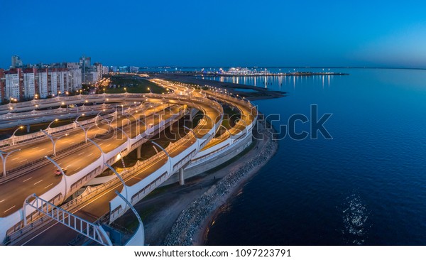 Road junction. High-speed roads in the city.\
Road on the outskirts of the city. Saint Petersburg. Russia. The\
Gulf of Finland.