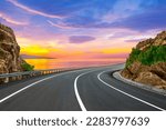 Road landscape at colorful sunset. Highway view on the sea. colorful seascape with beautiful road. highway scenery on ocean beach. coastal road in europe. summer trip on the road on the nature.