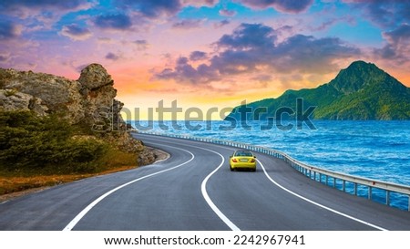 Road landscape at colorful sunset. Highway view on the sea. Mediterranean with beautiful road. Nature scenery on ocean beach. traveling by car on the holiday road in summer. driving on the vacation.