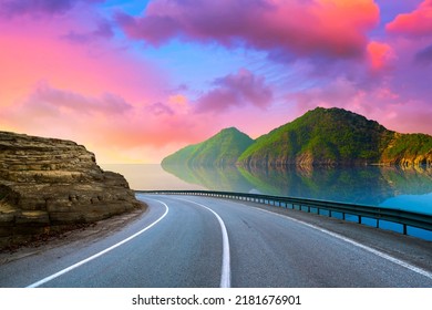 Road Landscape On The Beach. Beautiful Road On Coast. Highway Landscape At Colorful Sunset. Coastal Road In Europe. Stunning Sea With Summer Vacation. Island Beach And Highway View On Summer Holiday.