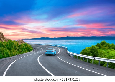 road landscape on the beach in summer. Car in motion in highway landscape under coastal road. Car driving on highway. Travel journey for summer trip on nature. Colorful sea in sunset. Mediterranean.