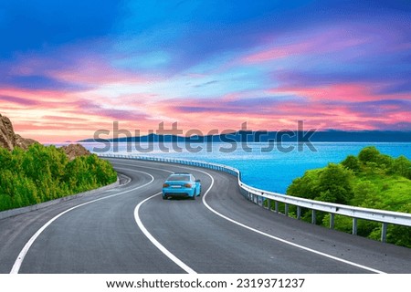 road landscape on the beach in summer. Car in motion in highway landscape under coastal road. Car driving on highway. Travel journey for summer trip on nature. Colorful sea in sunset. Mediterranean.