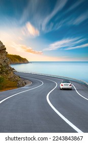 road landscape in summer. car driving on the road of europe. Highway scenery in beautiful nature. A white car on the road against the backdrop of a blue seascape. highway landscape on the ocean beach. - Shutterstock ID 2243843867
