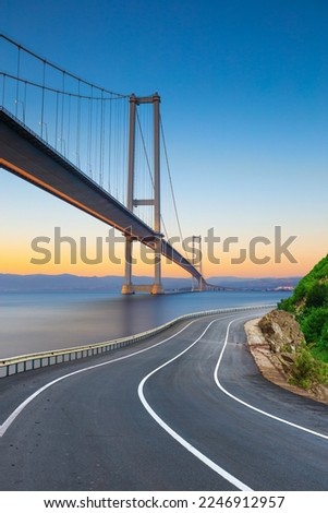 Road landscape at sunset on the beach. View of big highway bridge in summer. highway landscape at colorful sunset. Turkey journey in coastal road. Travel journey for summer vacation on beautiful road.