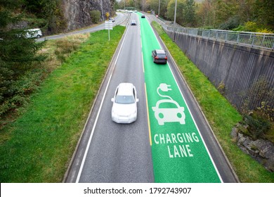 Road with lane for wireless charging of electric vehicles