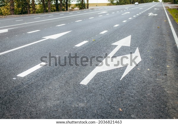 Road lanes with white\
arrow markings