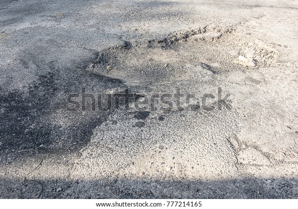 The road is large hole and has a rough\
surface. It is dangerous for people to use the car. Because it will\
cause accidents. Waiting to be\
repaired.