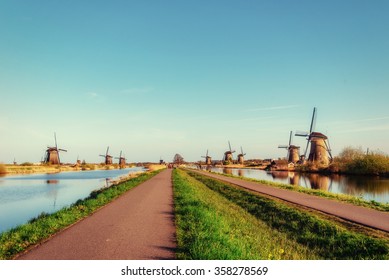 The road leading to the Dutch windmills from the canal in Rotterdam. Holland. Netherlands 