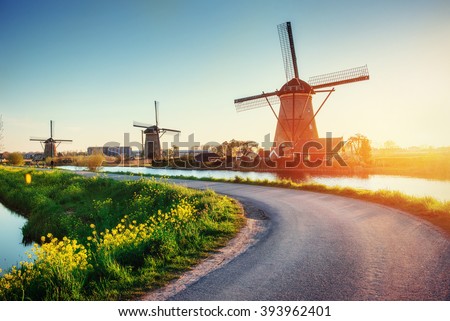 The road leading to the Dutch windmills from the canal in Rotterdam. Holland. Netherlands 