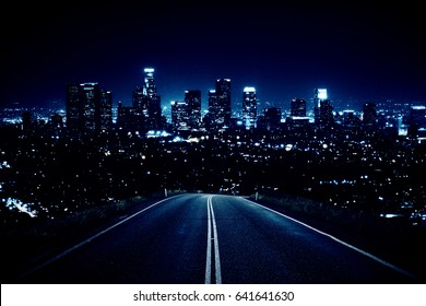 Road leading to modern illuminated night city. Forward concept