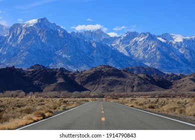 Road leading to snow capped mountains