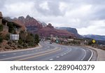 Road leading to uptown Sedona with some rock formation in the background.