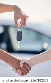 The Road Less Traveled Is Less Traveled For A Reason. Shot Of A Unrecognizable Woman Shaking Hands With A Man As She Gets A Car Key Outside.