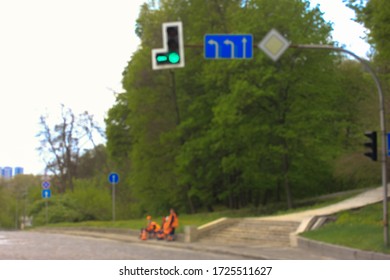 Road Maintenance Crew And Signs For Drivers Of Cars In The City: A Green Traffic Signal