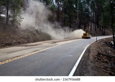 Road Maintenance Crew Using Heavy Machinery To Sweep Soil Leftovers After Recent Landslide In California