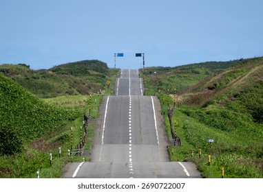 A road with many ups and downs through the hills