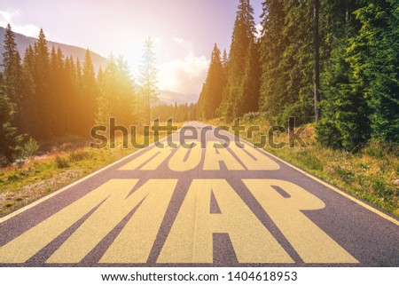 Road map written on street in the mountains. Road map text on the highway.