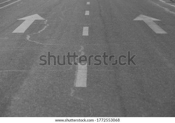 Road marking arrow on\
asphalt