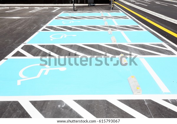 Road marking for handicapped parking stall in a parking\
lot 