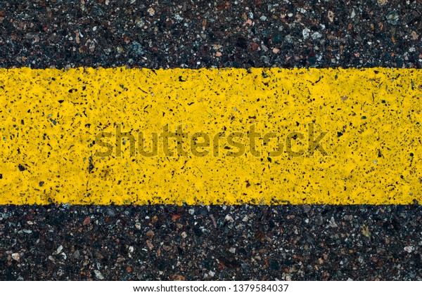 Road marking line with yellow paint on asphalt.
Marking the motorway.
Close-up