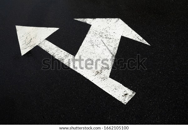 Road marking lines. Go straight and turn arrows\
on the asphalt surface.