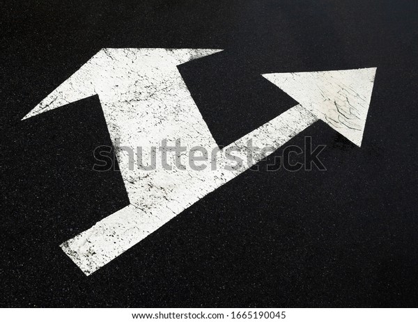 Road marking lines. Go straight and turn arrows
on the asphalt surface.