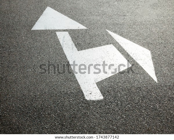 Road marking lines. Go straight and turn arrows
on the asphalt surface.