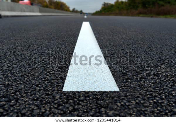 Road marking on the asphalt of the new\
road. Road construction.