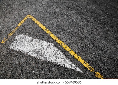 Road marking, white stripe and corner of yellow borders line over black asphalt pavement, background photo - Powered by Shutterstock