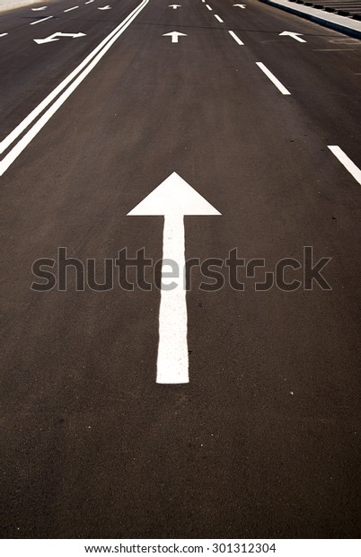 Road markings in the form of arrows on the asphalt\
road in the city