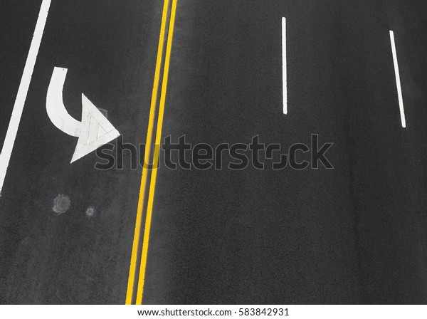 Road markings on\
asphalt on the street of Manhattan in New York City. Iridescent\
spot of gasoline on\
asphalt
