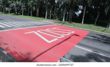 Road Markings, Red Road Markings With The Words ZOSS Which Means School Safe Zone (Zona Selamat Sekolah) Is Used To Cross Students At Schools.