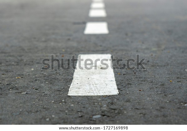 Road Marks. white stripes on the road stretching\
into the distance