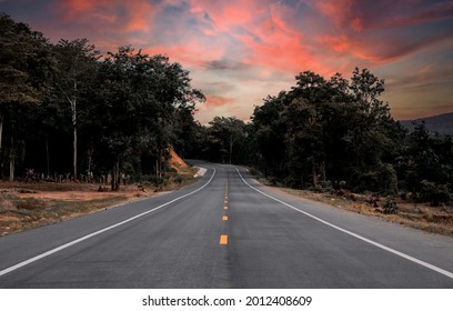 A Road In The Middle Of Nature With A Golden Yellow Sky