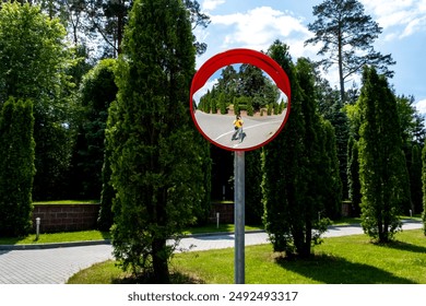 Road mirror, spherical observation at an intersection, photographer's reflection in the mirror