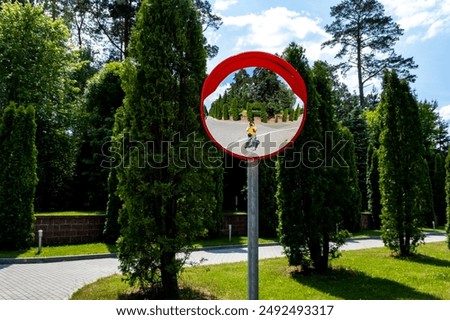 Road mirror, spherical observation at an intersection, photographer's reflection in the mirror