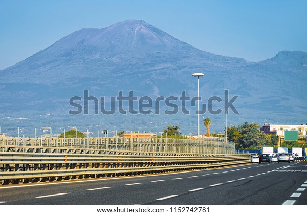 Road with Mount\
Vesuvius mountain in Italy\
