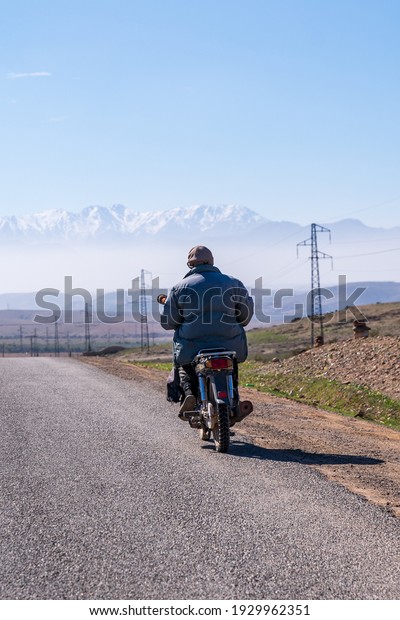 A road to the\
mountain in bike , old man\
trip