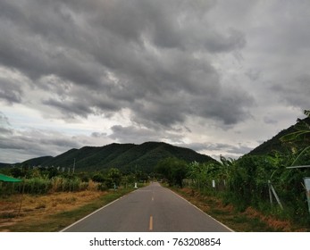 Road ,Mountain and Rain Clouds with tree.