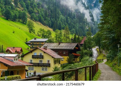 road in the mountains of Austria against the backdrop of cozy houses