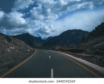 A road with mountains in the background