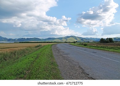 Road, mountains and clouds

